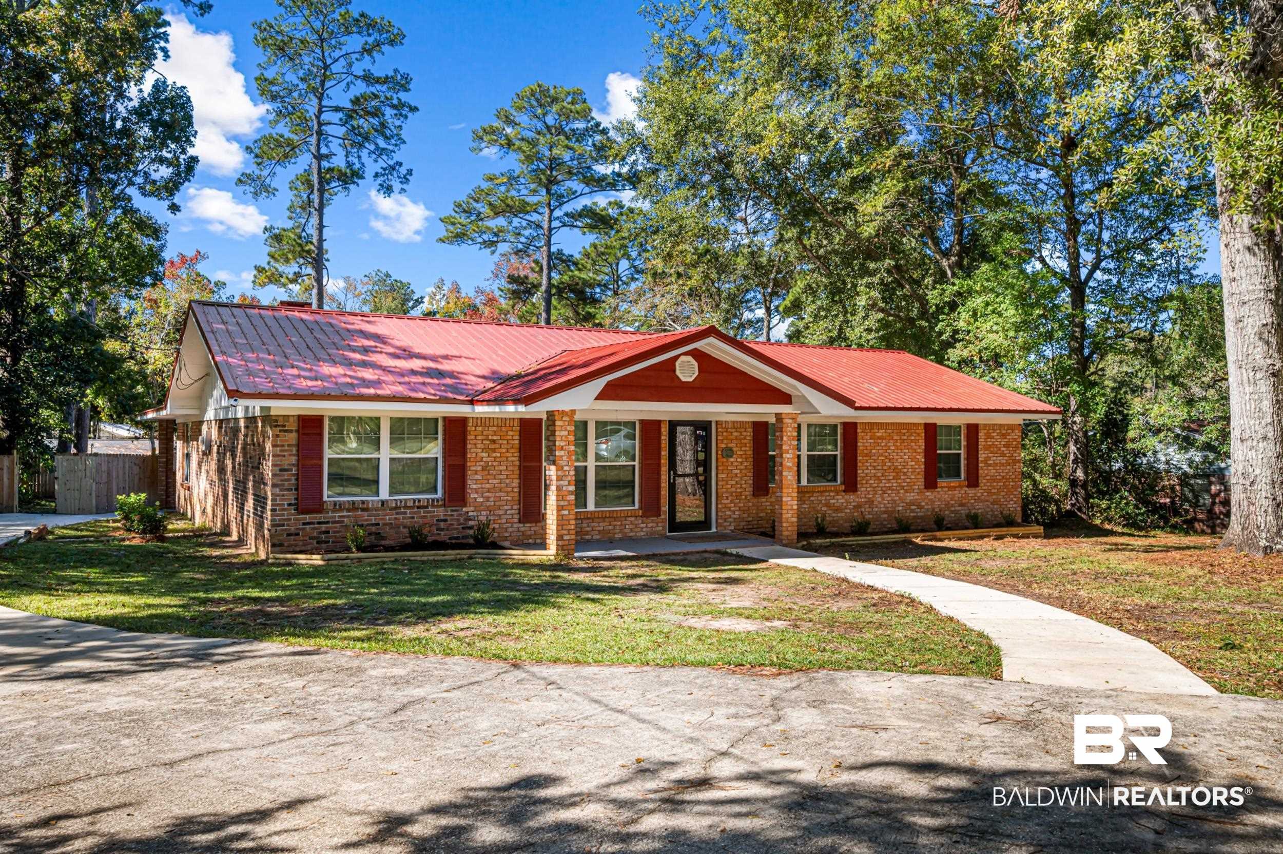 1605 Collier Avenue Bay Minette, AL 36507 - Photo 2 of 36 Ranch-style house featuring a metal roof, brick siding, and a porch