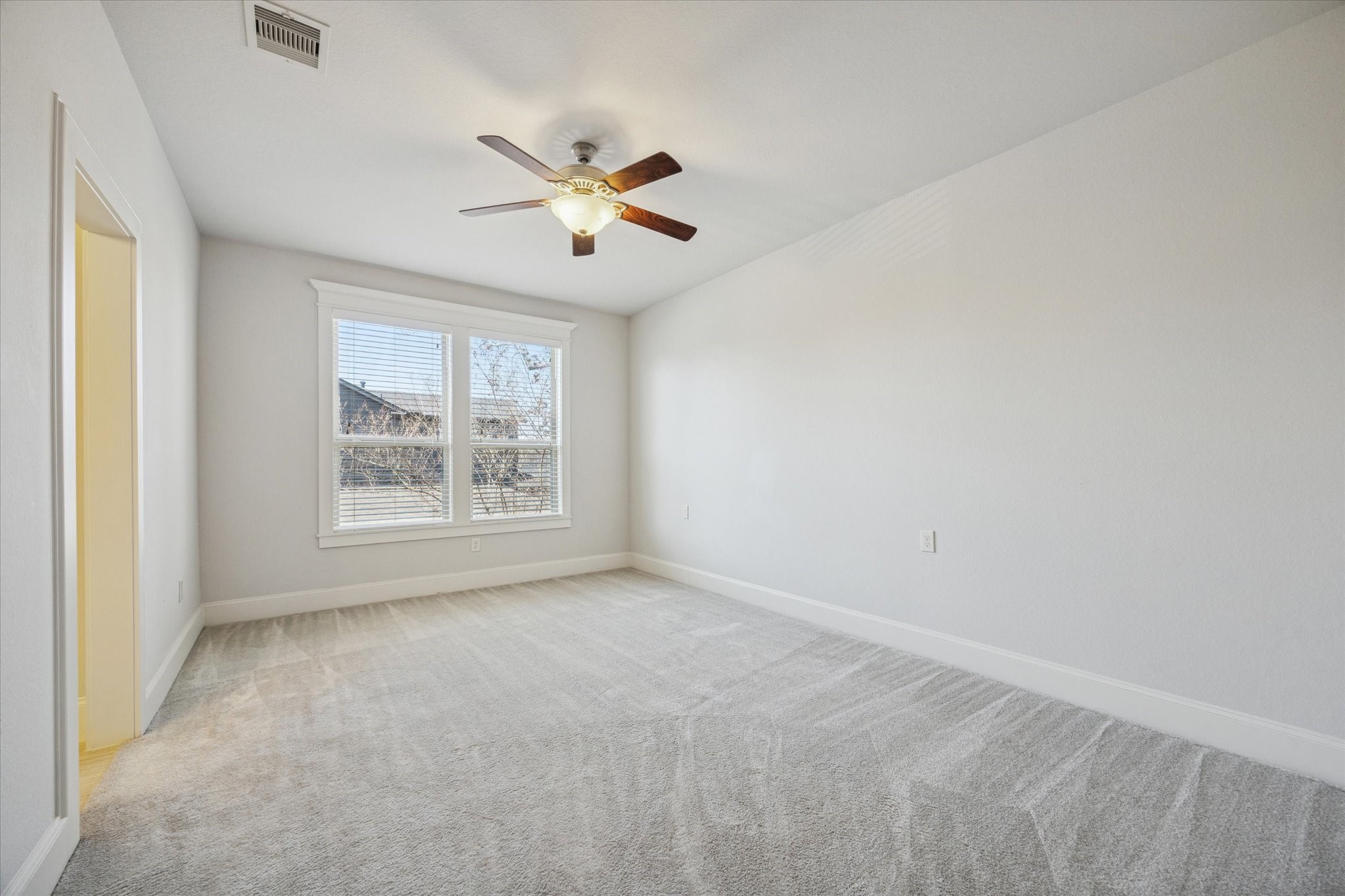 1802 Wakefield Drive Houston, TX 77018 - Photo 32 of 47 Guest room features a large window, ceiling fan with light kit and a neutral color palette with ensuite bathroom.