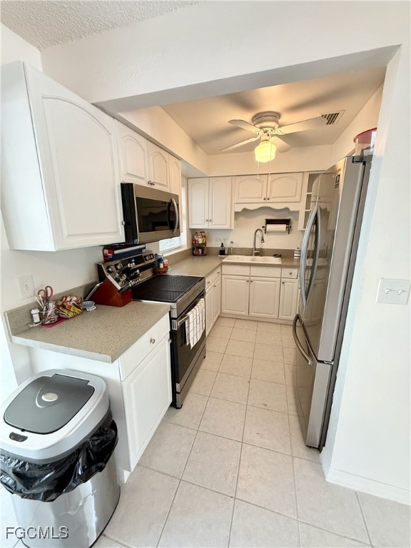 314 Vermont Way Lehigh Acres, FL 33936 - Photo 11 of 45 a kitchen with a sink a stove and a refrigerator