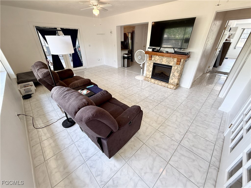 314 Vermont Way Lehigh Acres, FL 33936 - Photo 17 of 45 a living room with furniture and a flat screen tv