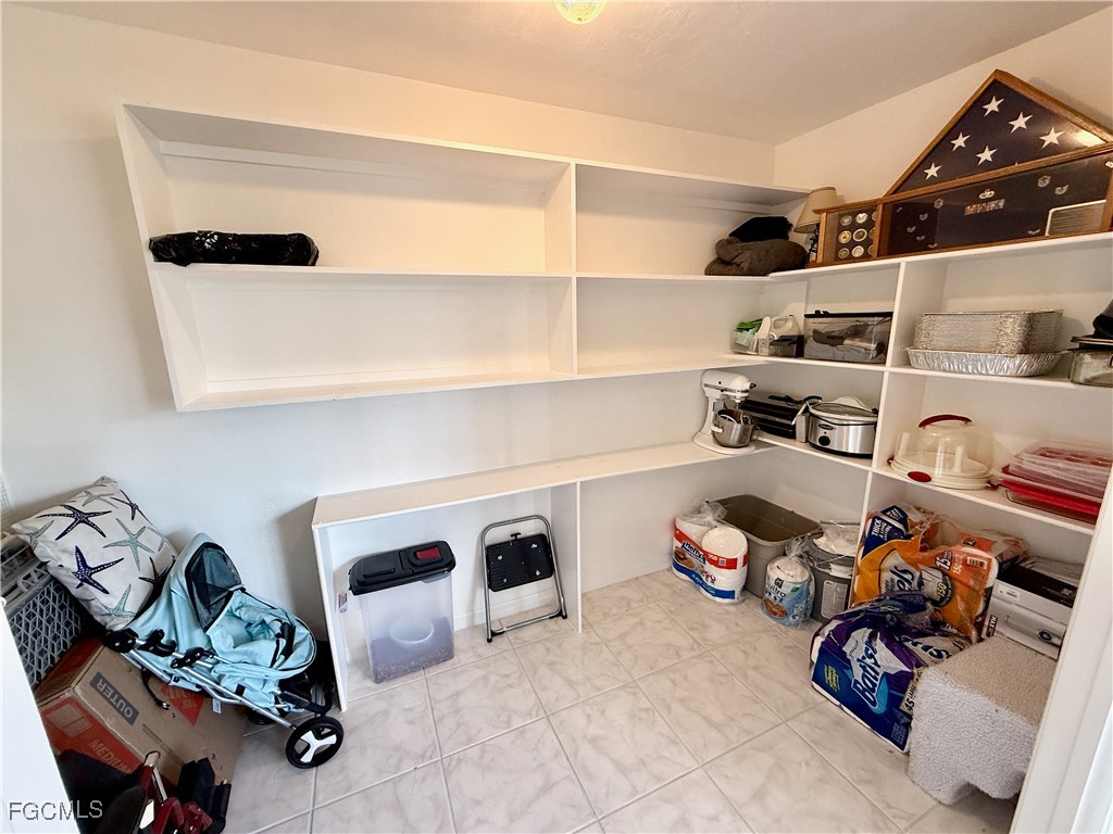 314 Vermont Way Lehigh Acres, FL 33936 - Photo 18 of 45 a view of walk in closet with clothes and shoes