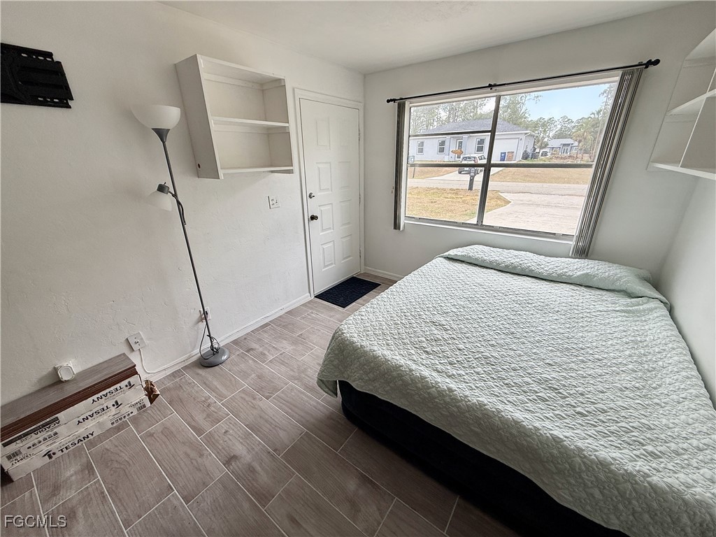 314 Vermont Way Lehigh Acres, FL 33936 - Photo 20 of 45 a bedroom with a bed and a window