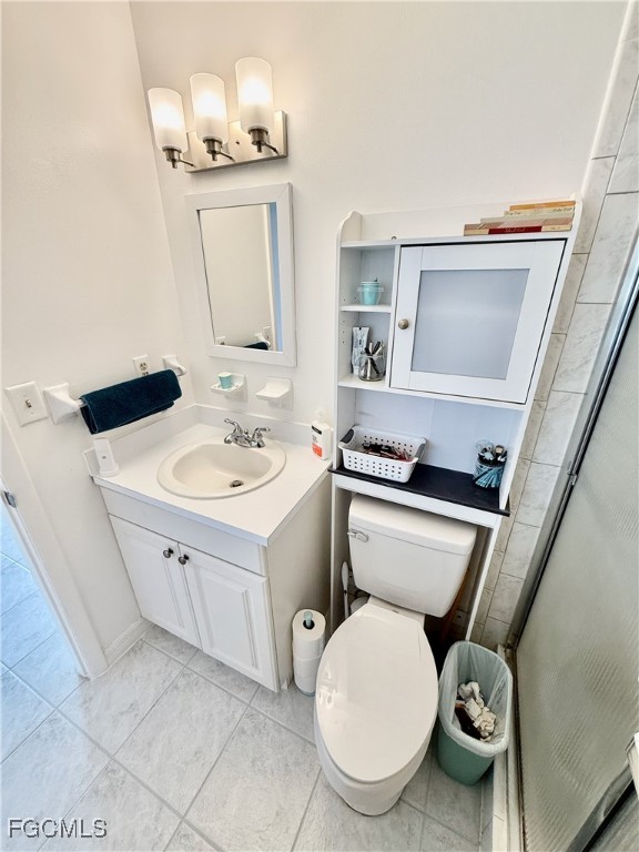 314 Vermont Way Lehigh Acres, FL 33936 - Photo 26 of 45 a white toilet sitting next to a bathroom sink