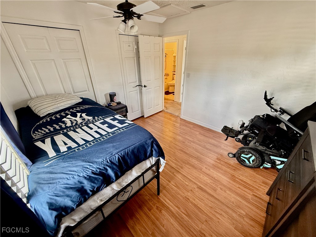 314 Vermont Way Lehigh Acres, FL 33936 - Photo 29 of 45 a bedroom with a bed and wooden floor