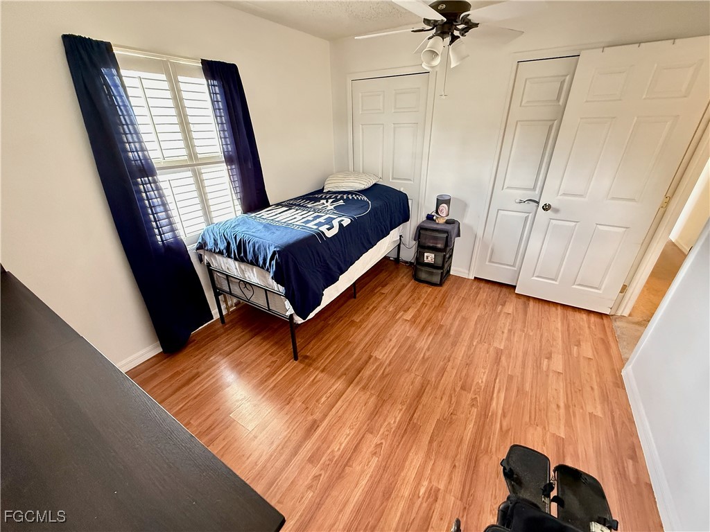 314 Vermont Way Lehigh Acres, FL 33936 - Photo 30 of 45 a bed sitting in a bedroom next to a window