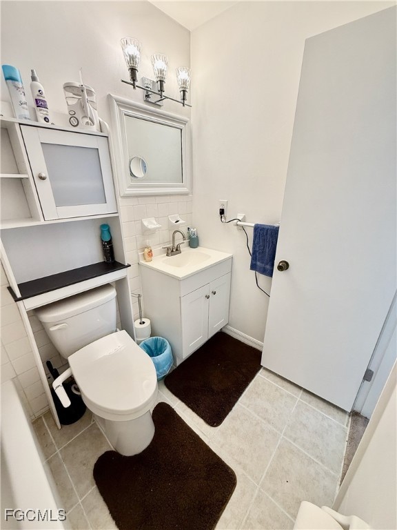 314 Vermont Way Lehigh Acres, FL 33936 - Photo 33 of 45 a bathroom with a toilet a sink and mirror