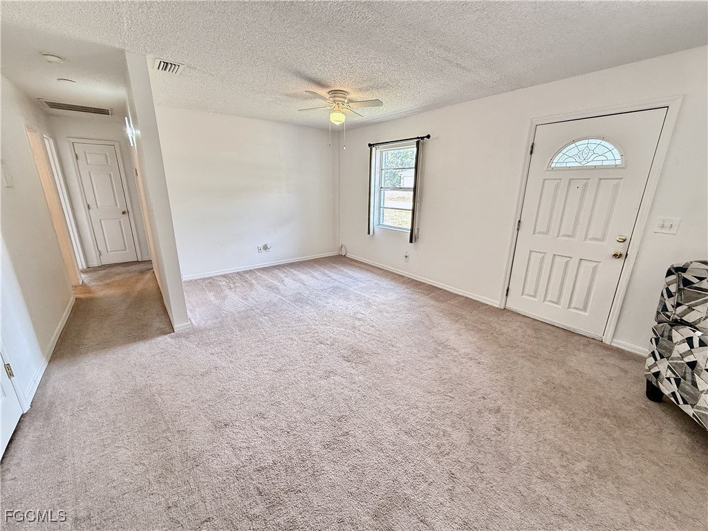 314 Vermont Way Lehigh Acres, FL 33936 - Photo 4 of 45 an empty room with windows