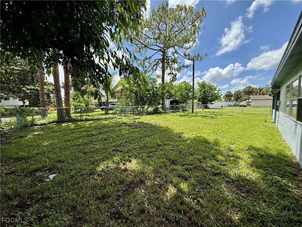 314 Vermont Way Lehigh Acres, FL 33936 - Photo 41 of 45 a big yard with lots of green space and trees