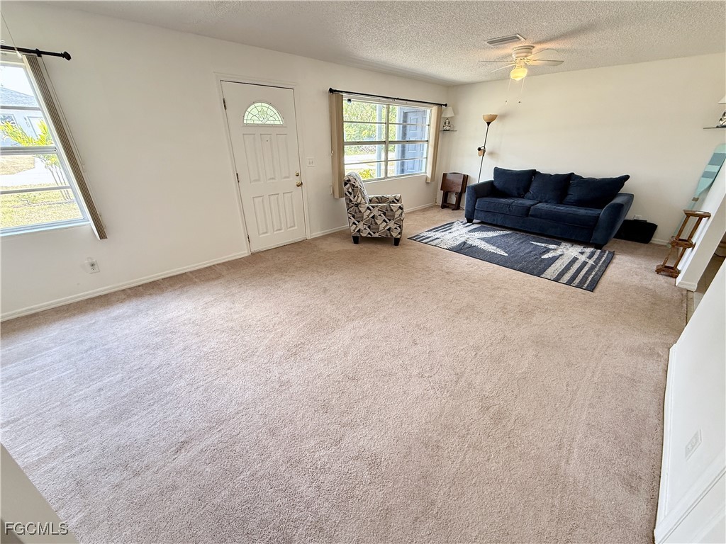 314 Vermont Way Lehigh Acres, FL 33936 - Photo 5 of 45 a living room with furniture and a window