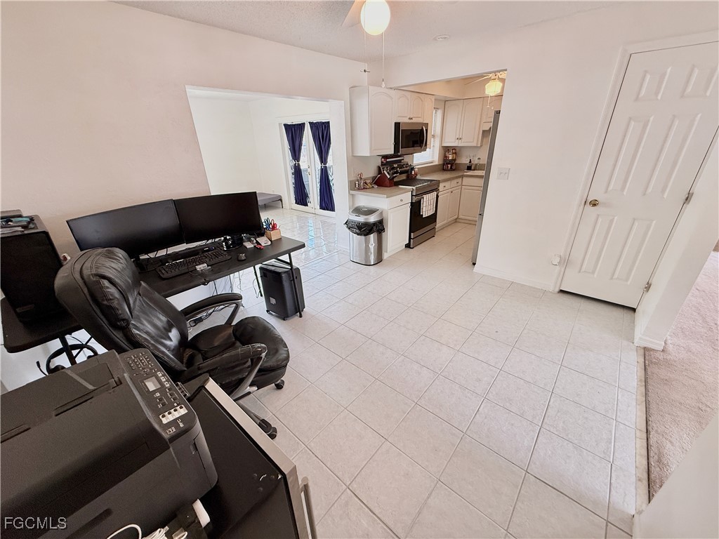 314 Vermont Way Lehigh Acres, FL 33936 - Photo 10 of 45 a view of a workspace with furniture and a window