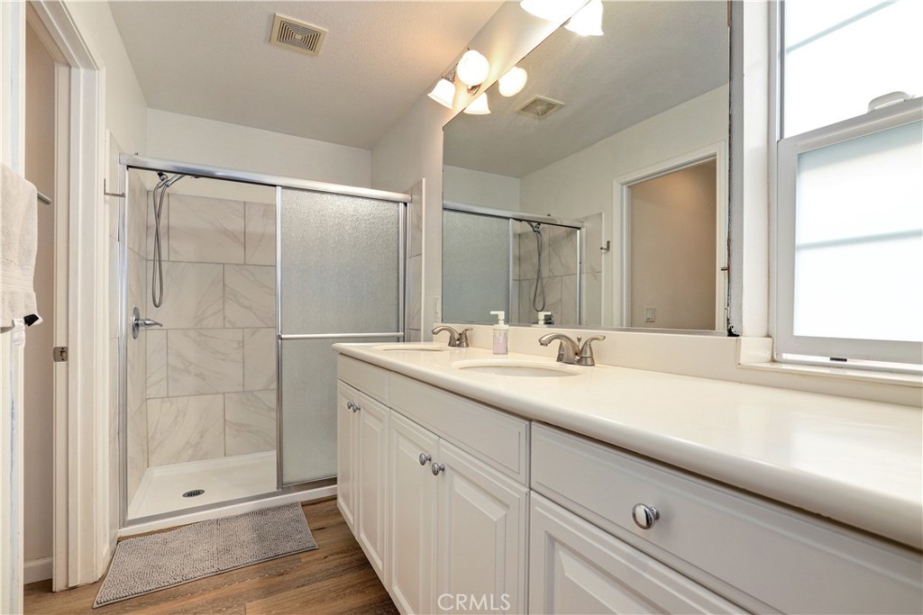 28364 Mirabelle Lane Saugus, CA 91350 - Photo 13 of 32 a bathroom with a shower sink and mirror