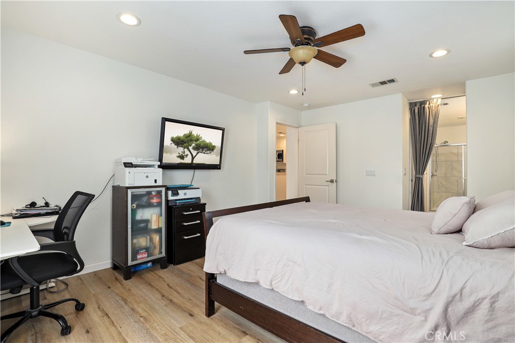 28364 Mirabelle Lane Saugus, CA 91350 - Photo 16 of 32 a bedroom with a bed a desk and chair