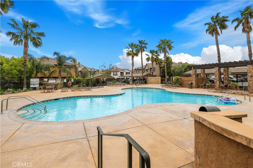 28364 Mirabelle Lane Saugus, CA 91350 - Photo 25 of 32 a view of a swimming pool with a lawn chairs under an umbrella