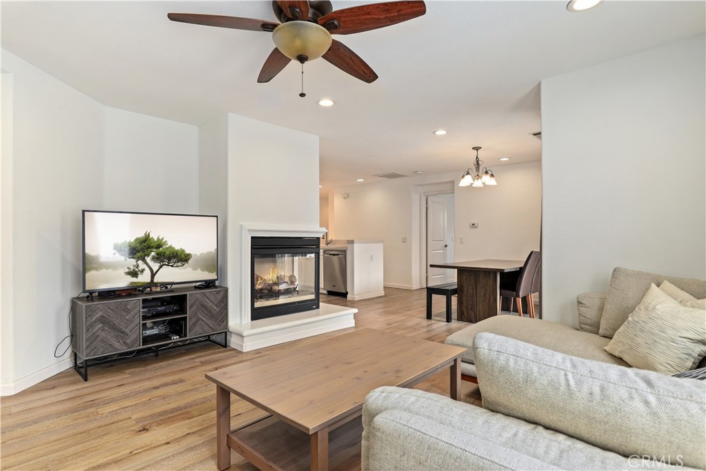 28364 Mirabelle Lane Saugus, CA 91350 - Photo 9 of 32 a living room with furniture a flat screen tv and a fireplace