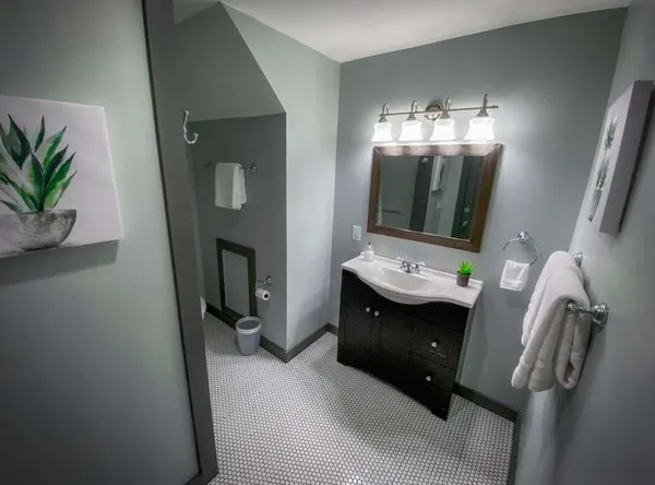 a bathroom with a sink and mirror