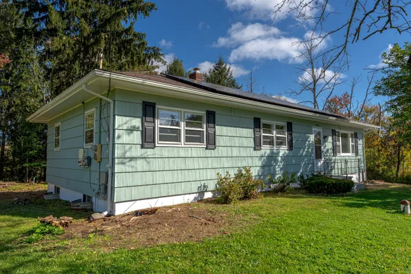 a front view of a house with a garden