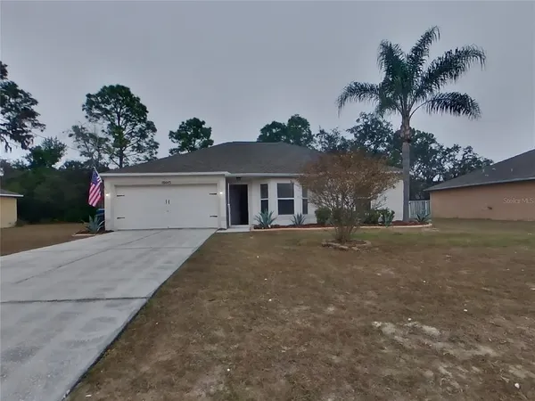 front view of a house with a yard and a garage