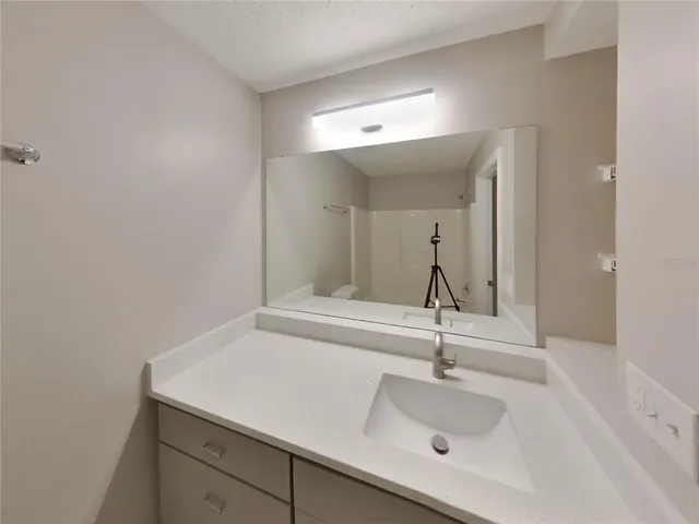 a bathroom with a sink and mirror