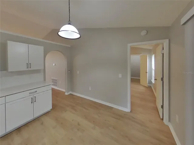 a view of a room with window and wooden floor