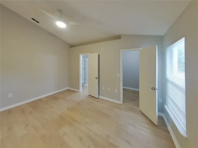 an empty room with closet and a bathroom
