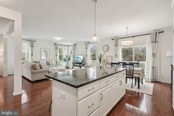 a large white kitchen with stainless steel appliances