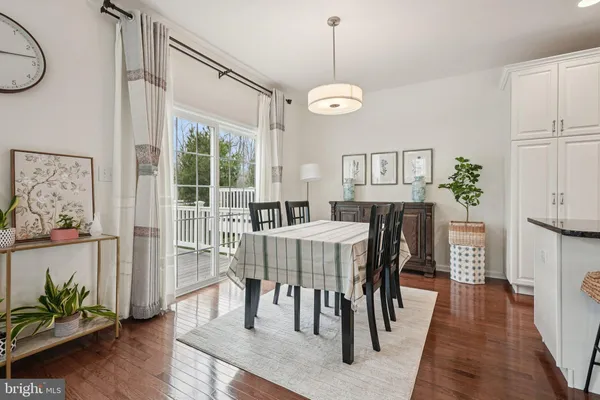 a large white kitchen with a large window and stainless steel appliances
