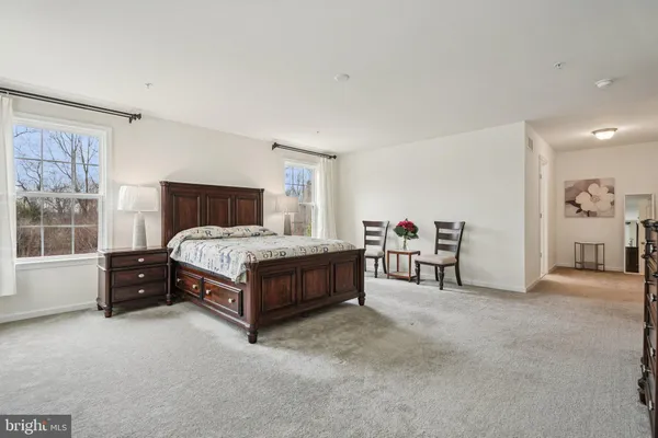 a bed room with a bed and a chair