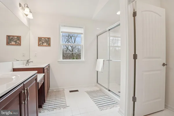 a view of a bathroom with a sink and a mirror