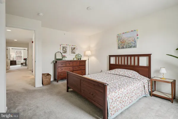 a bedroom with a bed and dresser