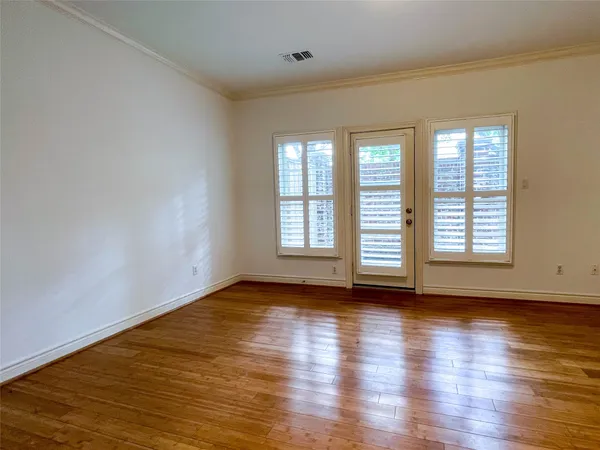a view of a room with wooden floor and a bathroom