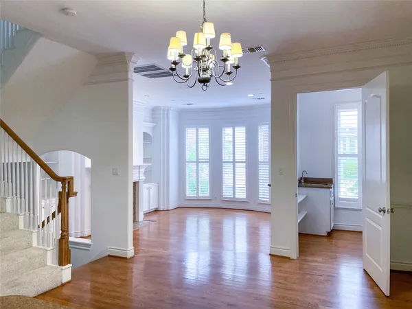 a view of empty room with wooden floor and fireplace