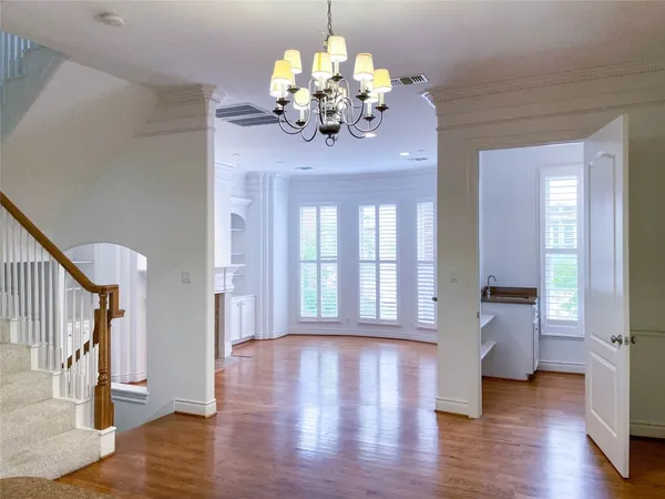 a view of empty room with wooden floor and fireplace