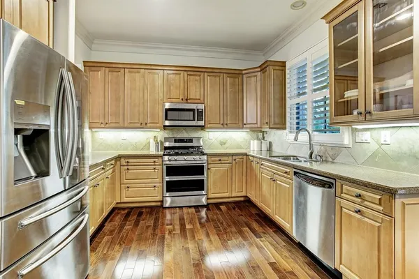 a view of an entryway with wooden floor