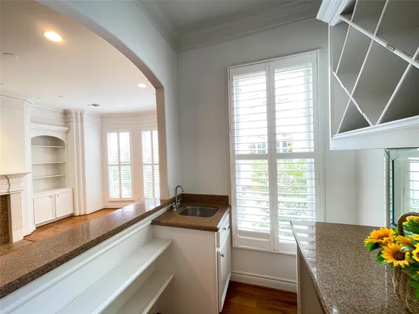 a spacious bedroom with a bed and a chandelier