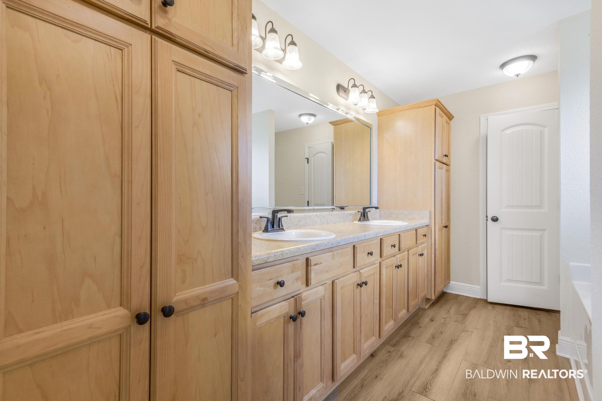 21580 Talbot Lane Robertsdale, AL 36567 - Photo 19 of 25 Bathroom featuring double vanity, light wood finished floors, and a bath