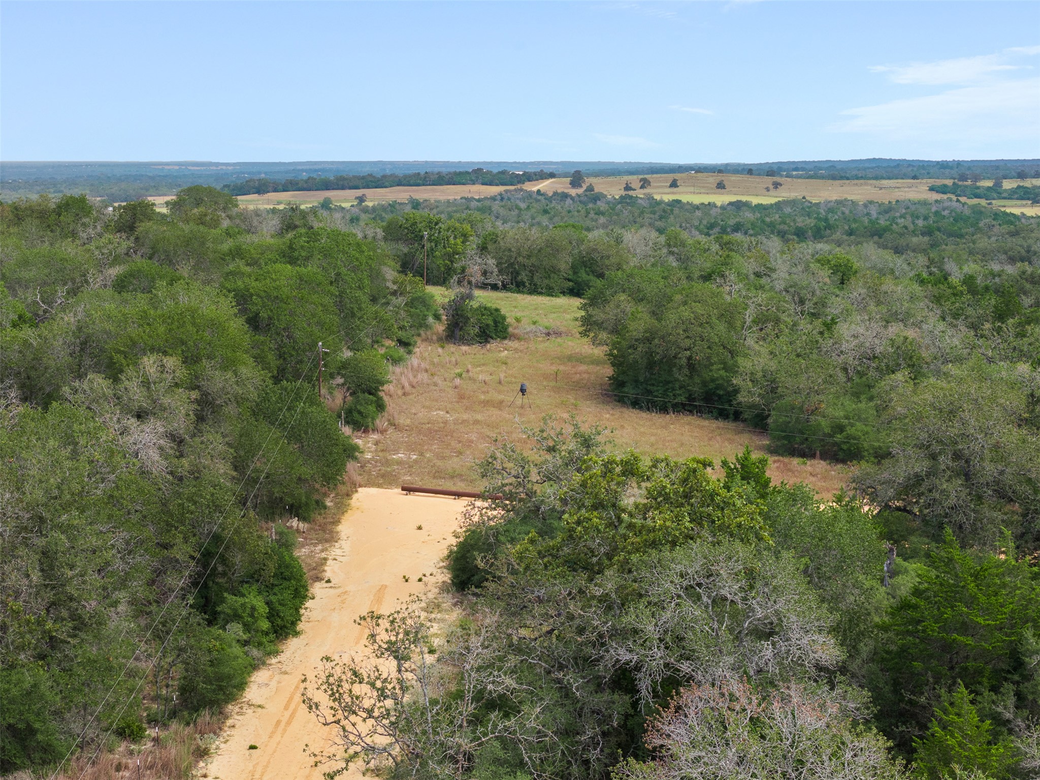 3301 Chuckwagon Road Harwood, TX 78632 - Photo 34 of 36 Vast green hillsides and open fields stretch toward the horizon under a clear sky.