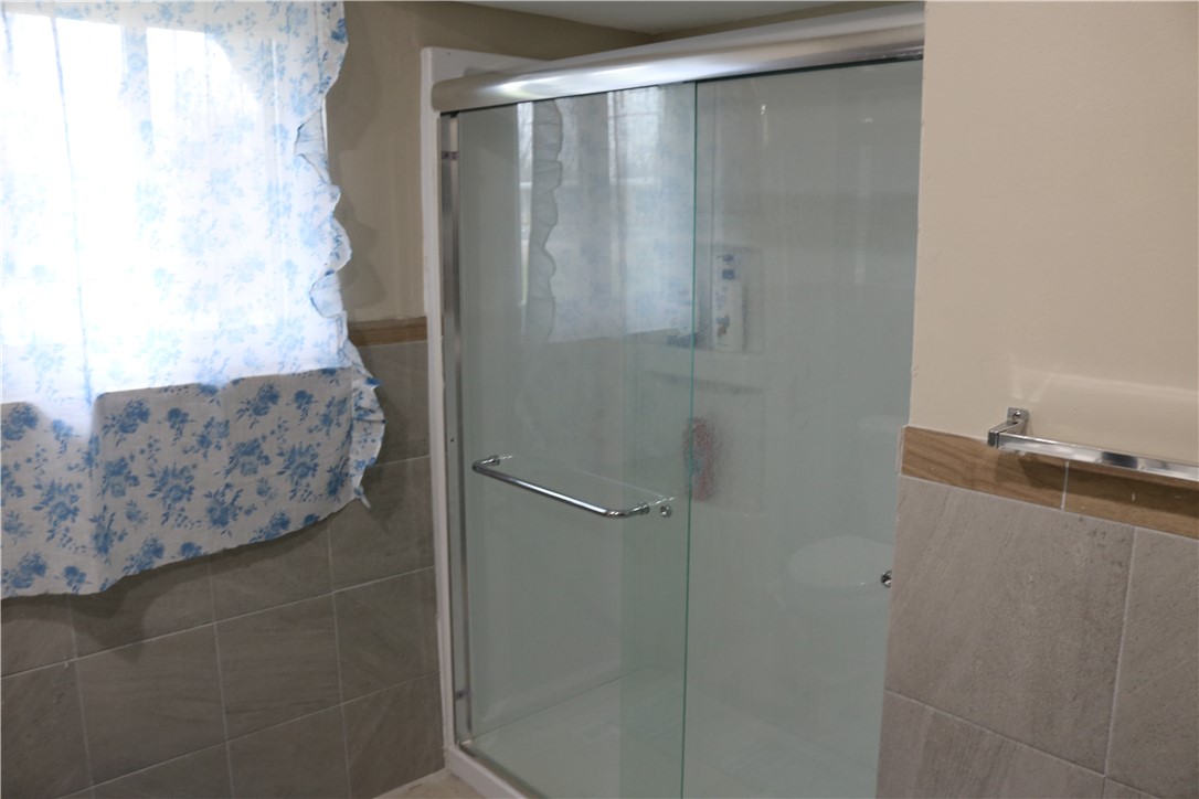 3185 Stop 8 Road Dayton, OH 45414 - Photo 10 of 10 This bathroom features a contemporary shower with sleek glass doors and tiled walls.