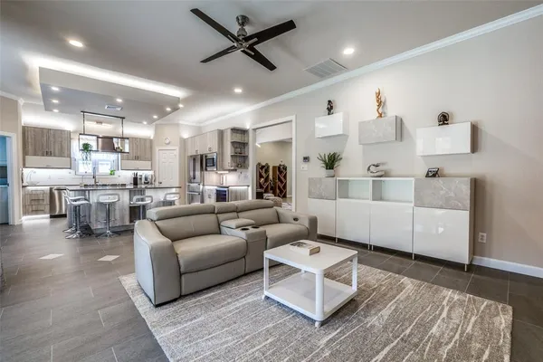 a living room with furniture and kitchen view