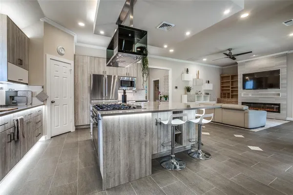a kitchen with a sink stainless steel appliances and cabinets