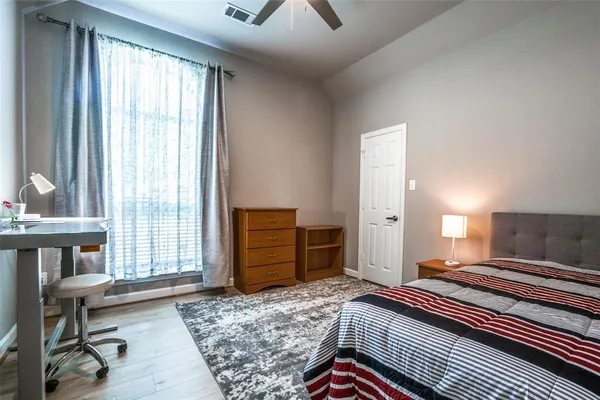 a bedroom with a bed and large windows