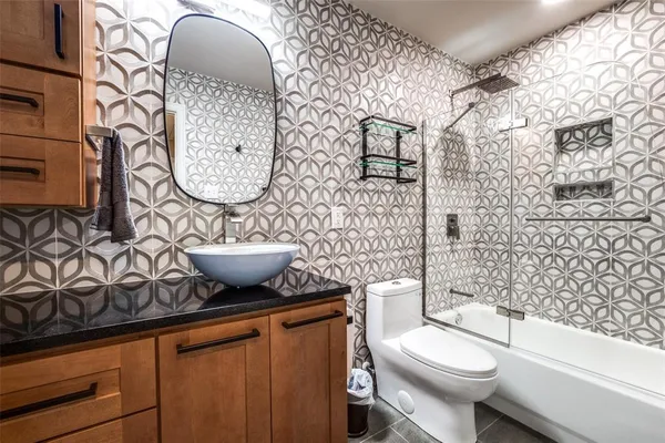 a bathroom with a toilet a sink and mirror