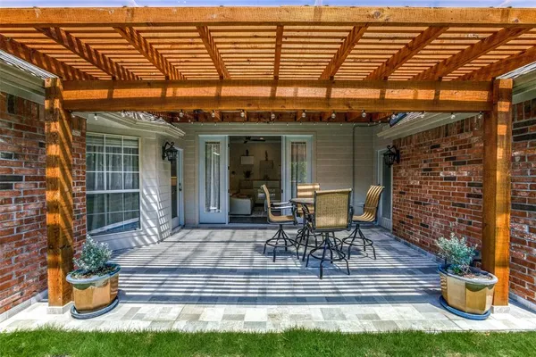 a view of a patio with table and chairs and potted plants