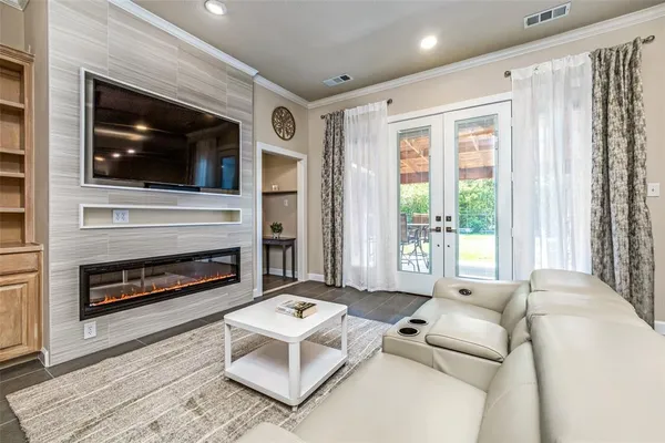 a living room with furniture a flat screen tv and a fireplace