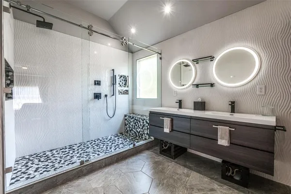 a bathroom with a double vanity sink mirror toilet and shower