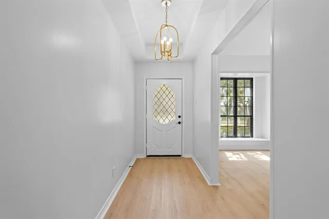 a view of an entryway with wooden floor