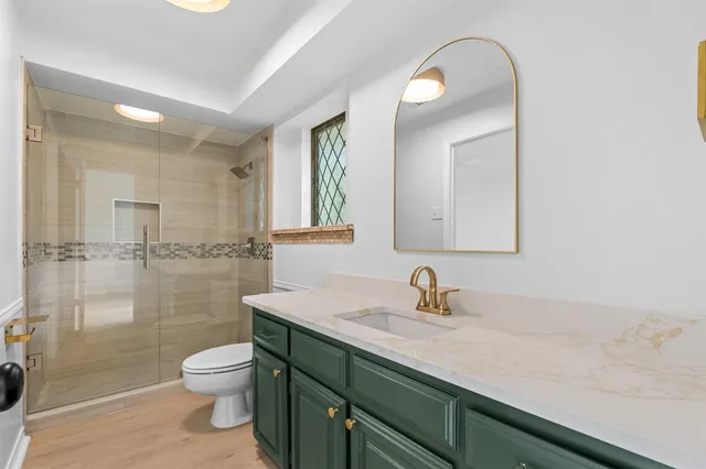 a bathroom with a sink a toilet and a mirror