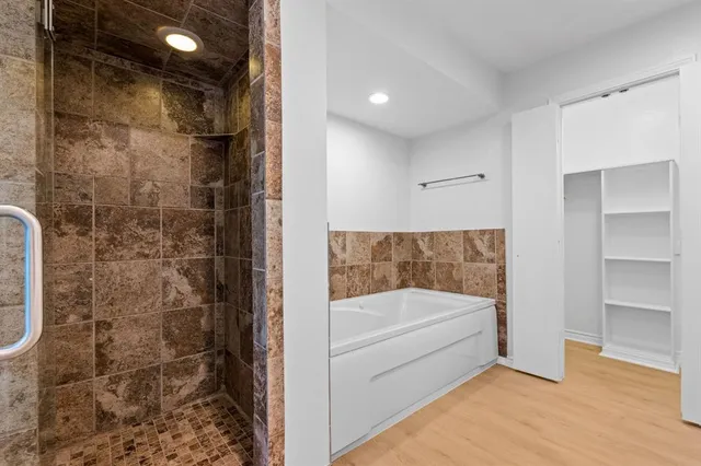 a bathroom with a tub and shower