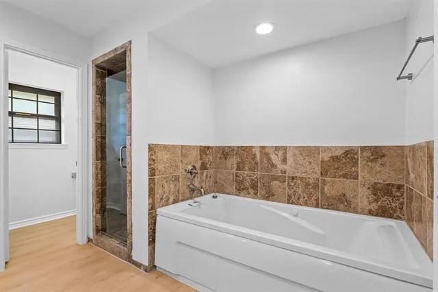 a bathroom with a bathtub and a shower