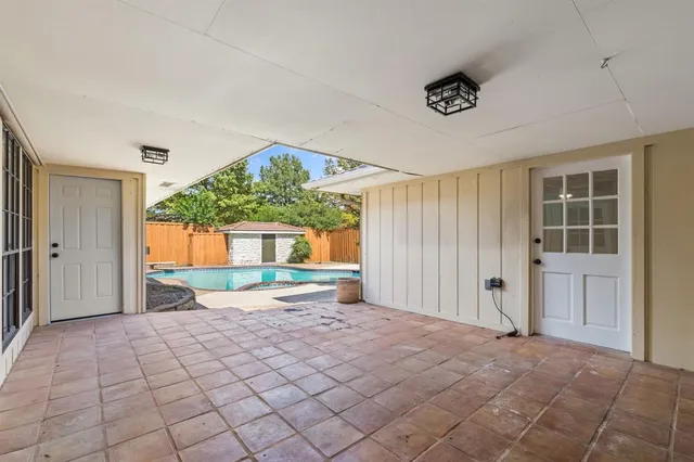 an empty room with a bathroom and a window