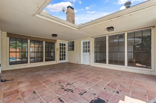 a view of a backyard with swimming pool